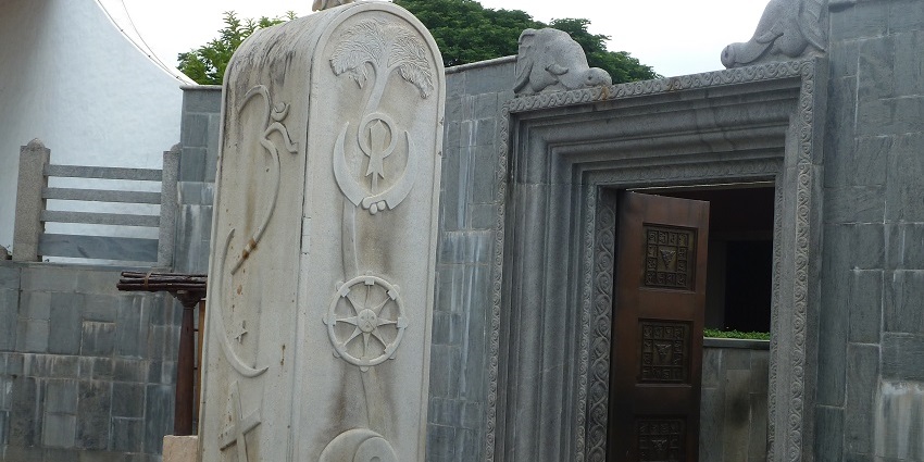 Dhyanalinga Sarva Dharma Sthamba, a tall pillar with intricate carvings in Dhyanalinga Temple.