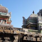 Front view of the top section of Sowmya Narayana Perumal Temple featuring idol sculptures on towers