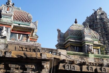 Front view of the top section of Sowmya Narayana Perumal Temple featuring idol sculptures on towers