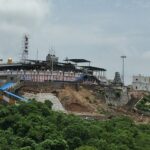 The Tiruttani Temple is perched atop a hill with grand entrance steps in greenery.