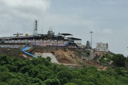 The Tiruttani Temple is perched atop a hill with grand entrance steps in greenery.