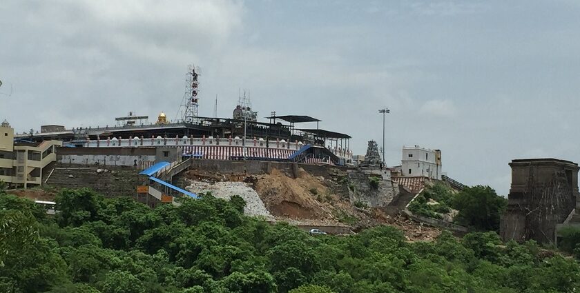 The Tiruttani Temple is perched atop a hill with grand entrance steps in greenery.