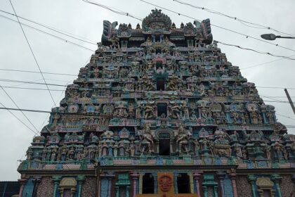 The Jambukeswarar Akilandeswari Temple shows a sign board and beautifully sculpted exterior