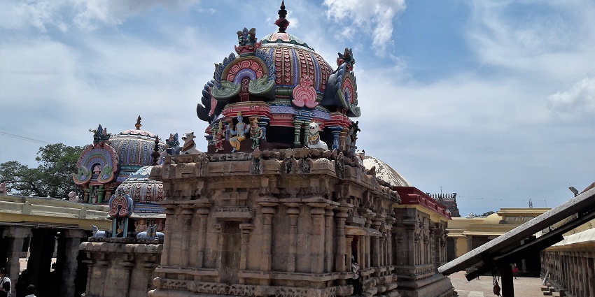 Thiruvenkadu Temple's architecture with detailed carvings and colourful gopuram.