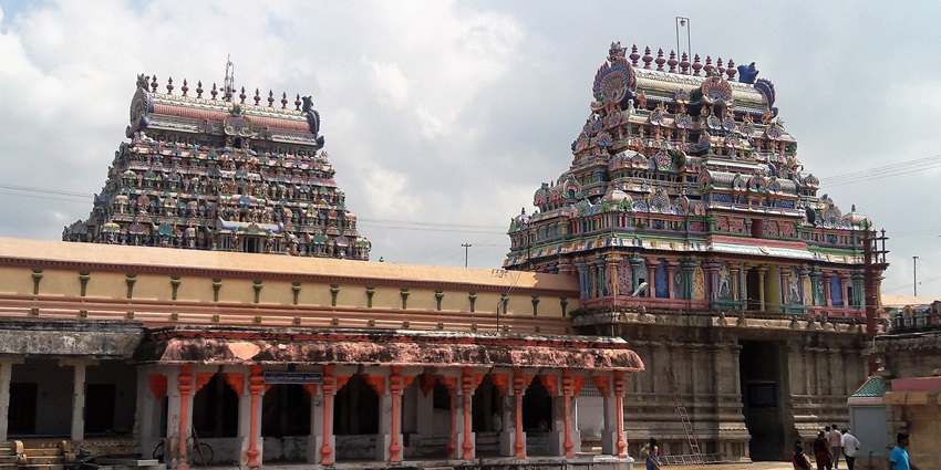 The entrance of the Thyagaraja temple with two vibrant gopurams and detailed architecture.