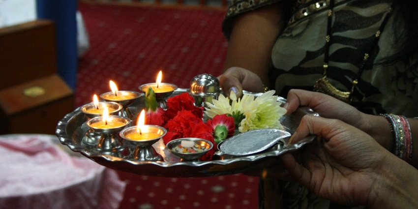Image of one of many aarti thali - women holding the thali and doing pooja rituals