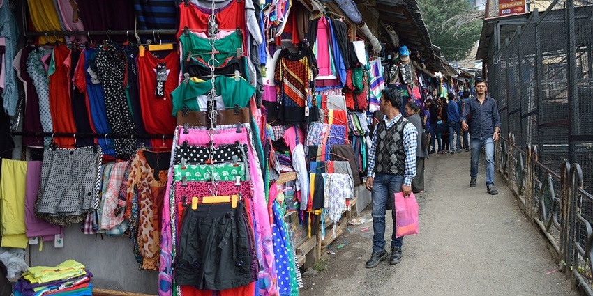 Vibrant market selling handicrafts, clothing, and authentic Tibetan cuisine.