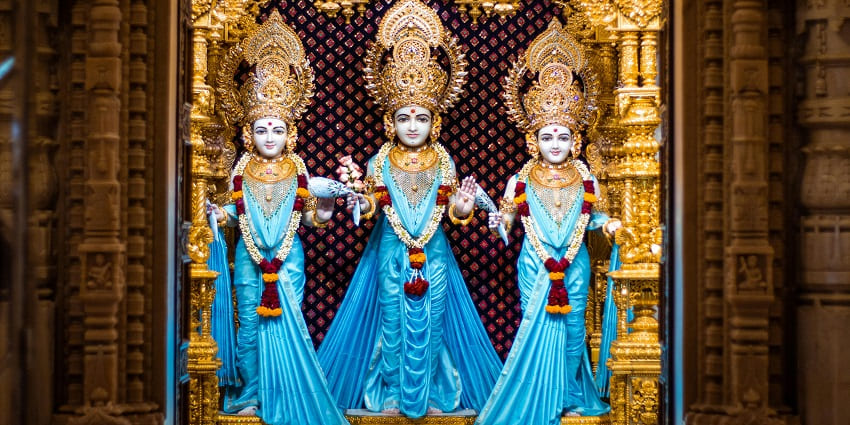 An inside view of Trimurti Devi Mandir in Uttarakhand featuring idols of three Gods.