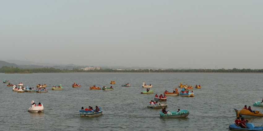 Image of Sukhna Lake Chandigarh during evening time - lake surrounded by boats