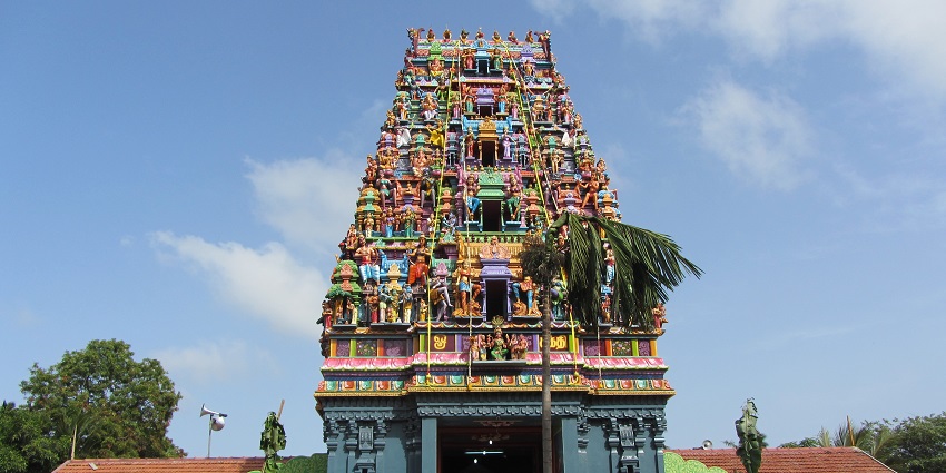 Walls and pillars of ancient Amman temple with intricate carvings of deities on stone