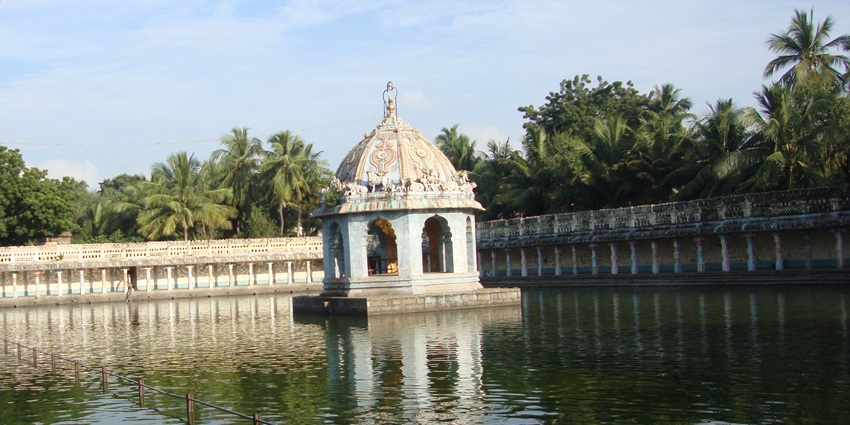 Ornate Dravidian temple façade featuring tiered gateway towers with detailed carvings.