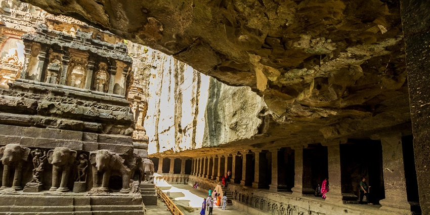 An image of a cave temple at featuring intricate rock-cut architecture and sculptures.