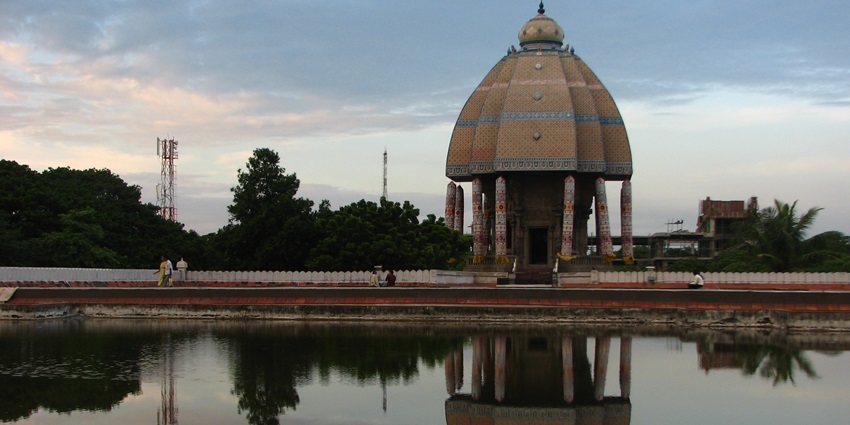 Valluvar Kottam with its grand structure and intricate details reflecting in the water