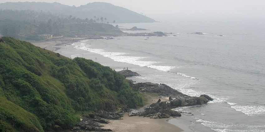 Serene Vanxim Island with lush greenery, sandy beaches, and calm waters under a bright blue sky