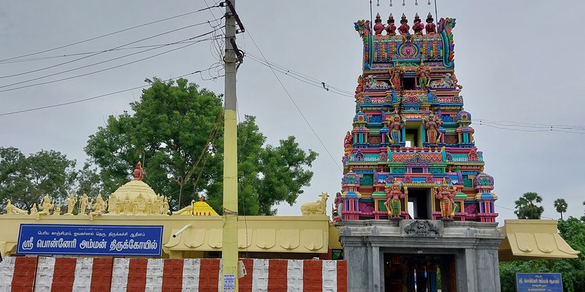 A frontal view of a traditional Hindu temple in Chennai with a tall and colourful gopuram