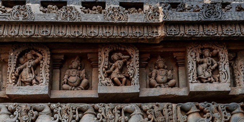 Ancient stone temple ruins with detailed carvings captured under a misty sky.