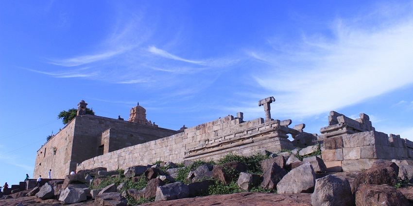 Ancient stone temple with intricate carvings in Tamil Nadu.