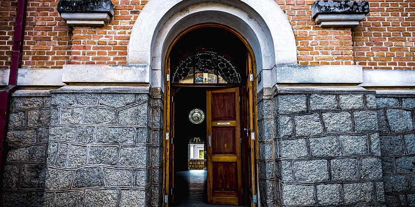 Entry gate with a door opened to Basilica with blending Gothic and Baroque styles.