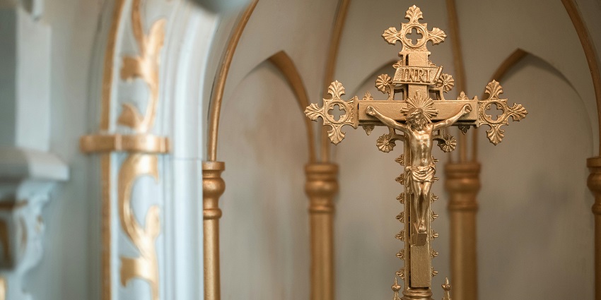 An image showing a Gold Crucifix, a treasured relic at the Velankanni Shrine Museum.