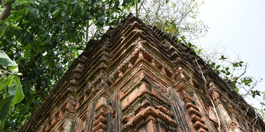 Vengeeswarar Temple with its traditional architectural carvings on ancient stone walls.