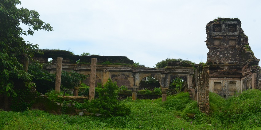 Vijaygarh Fort, a historic place to visit near Naugarh Fort, surrounded by tall trees and lush greenery