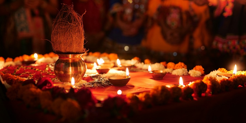 Decorated table with elegant candles, a vibrant vase of flowers, and a warm, inviting atmosphere