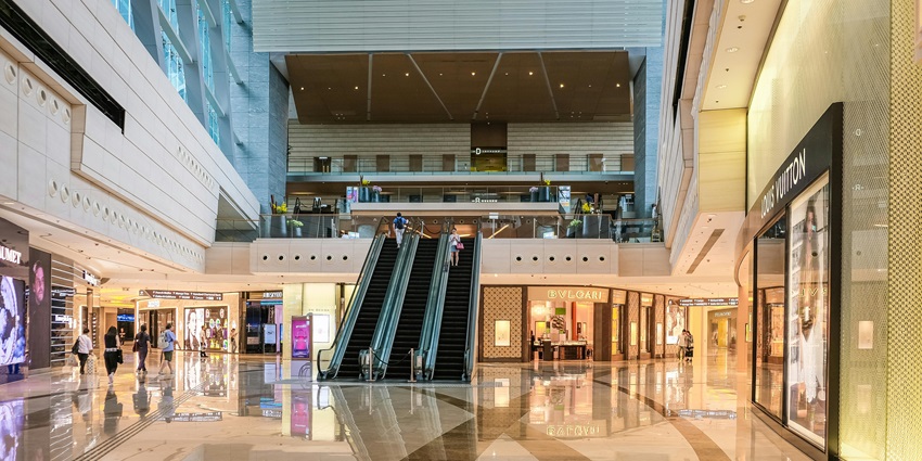 Modern Elante Mall illuminated at night, bustling with shoppers and vibrant storefronts for late-night shopping