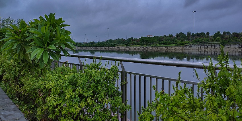 Scenic view of Gomti Riverfront in Lucknow, featuring illuminated pathways and greenery.