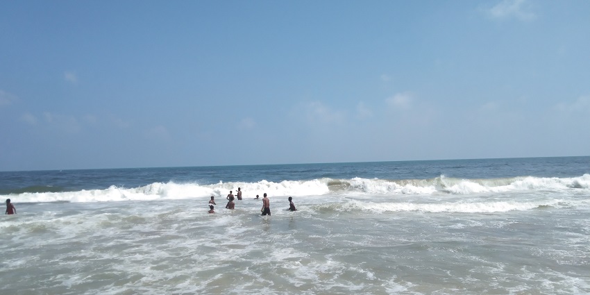 A view of Marina Beach with the ocean and sandy shore, a popular tourist attraction in Chennai.