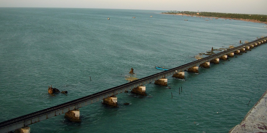 A picture of a gorgeous sea bridge with some strong waves breaking on the bout side.
