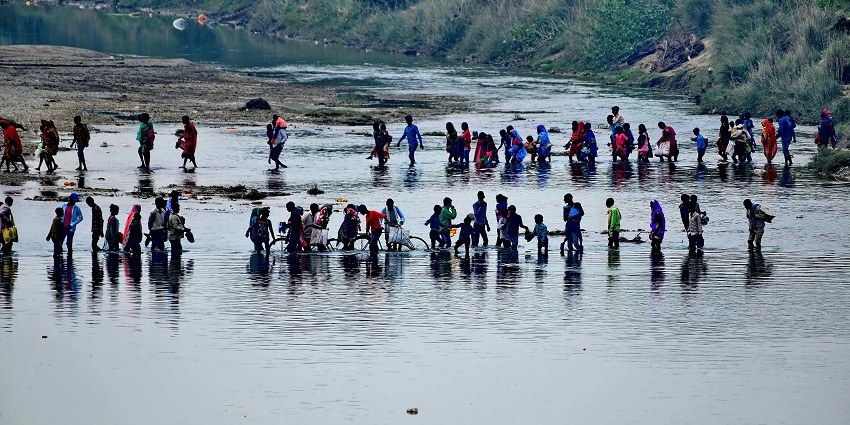View of people by the sandy shores performing a ritual of the festival
