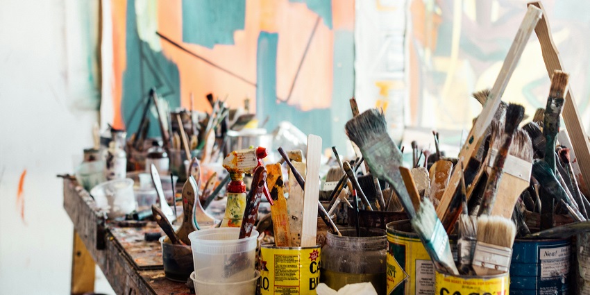 An image of a kid doing painting, one of the best things to do in Auroville, India.