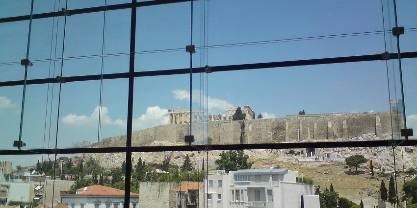 Inside the new Acropolis Museum building with an outer view visible from the glass.