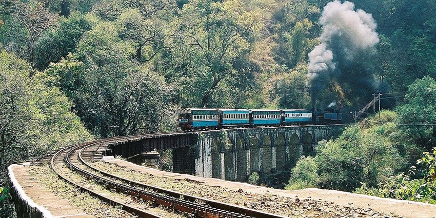 An image of a blue and black train in Nilgiri Mountain Railway
