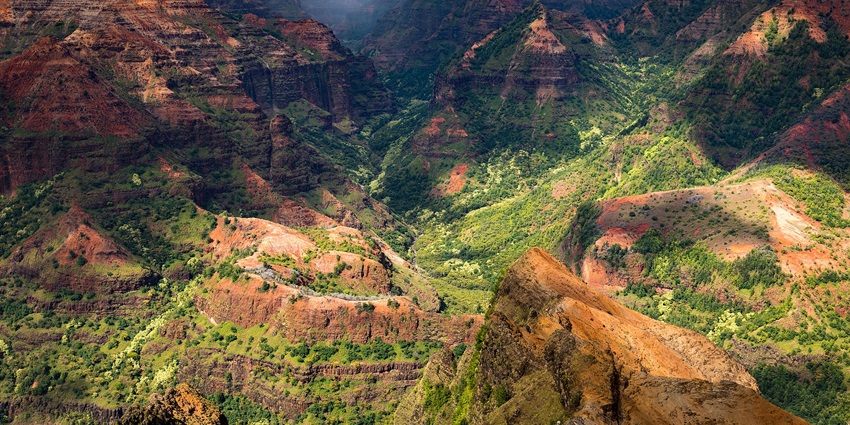 Waimea Canyon State Park from the top and the shadows created by clouds on the mountains