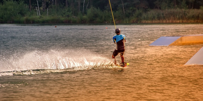 A picture of a wakeboarder enjoying the waves at Nagaon Beach water sports.