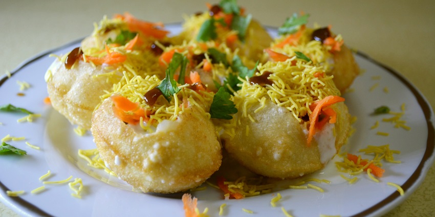 A picture of a delicious snack made with dahi and puri, served at a restaurant near Mahad temple