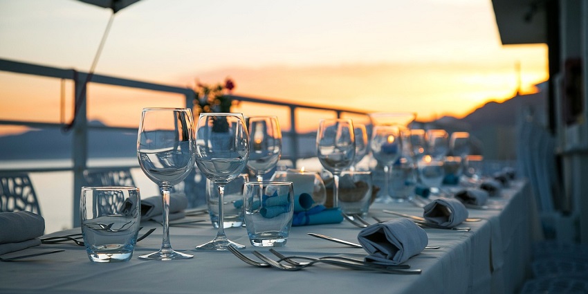 A view of an elegant table setting with glassware and cutlery arranged for a meal.