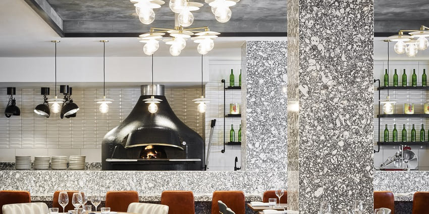 Vibrant kitchen scene in a restaurant showcasing various dishes and food preparations.