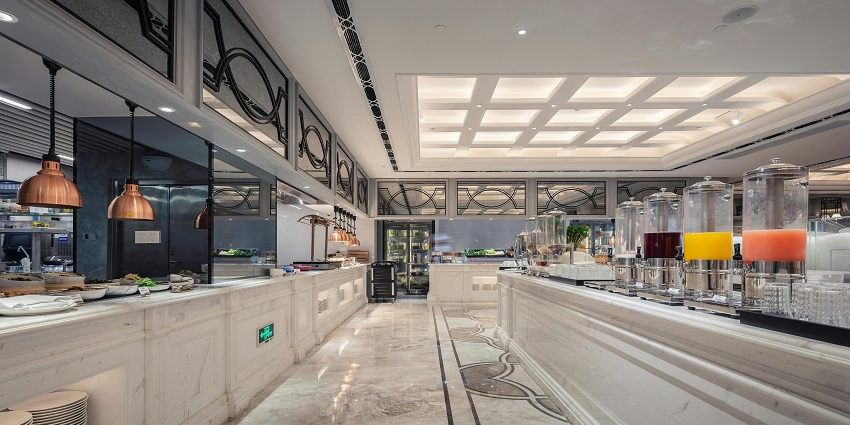 The interior of a hotel restaurant features elegant decor, cosy seating, and warm lighting.