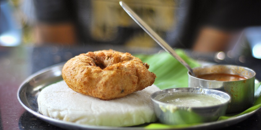 Traditional Chennai-style vada served on a plate with sambar