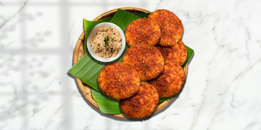 Top view of a traditional south Indian dish served on a banana leaf and plate with chutney
