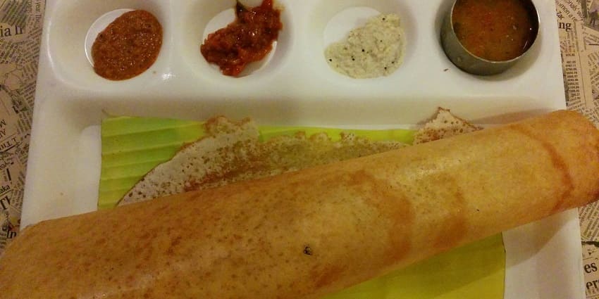An image of dosa served on a plate, a very popular food item in South India.