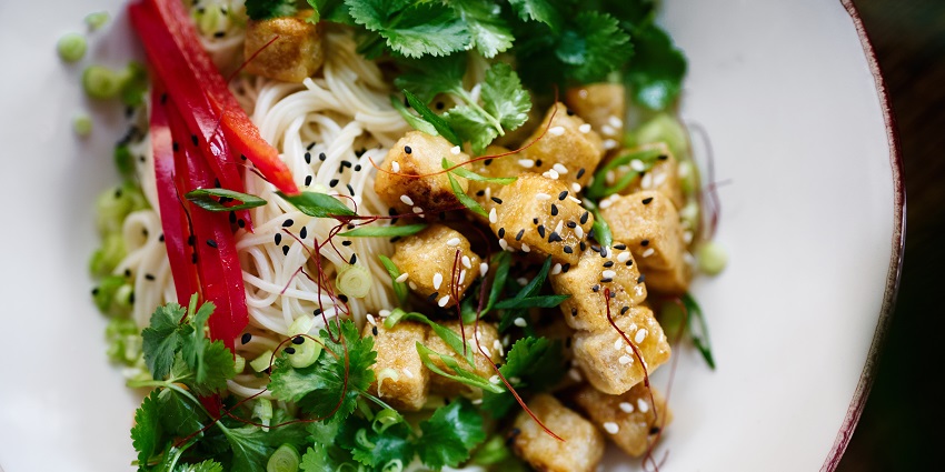 Fresh pasta salad garnished with coriander, offering a healthy and flavorful dish.