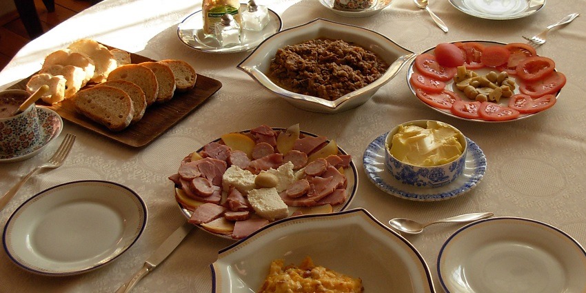 Polish cuisine, breakfast served with multiple dishes, salad, toast and two cups of coffee.