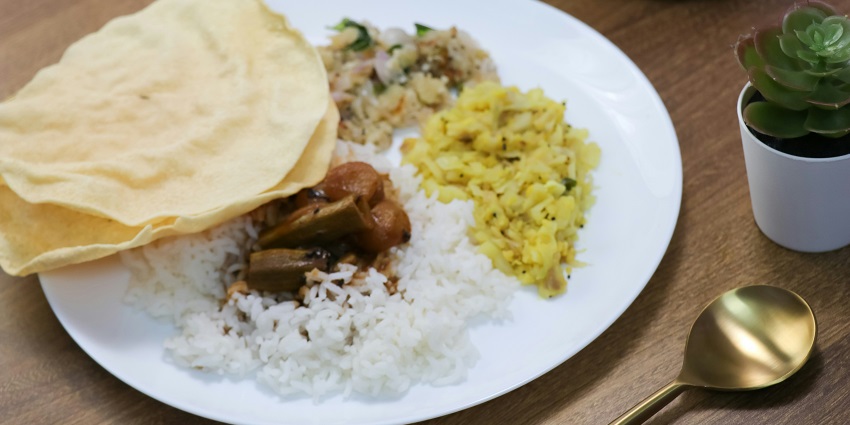traditional South Indian food with various colourful chutneys, rice and sambar.