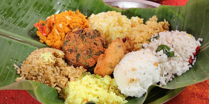 Traditional South Indian meal served on a banana leaf with different types of rice