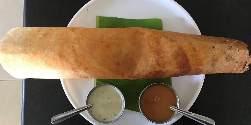 Masala Dosa, a popular south Indian dish, is served at a restaurant on a banana leaf.