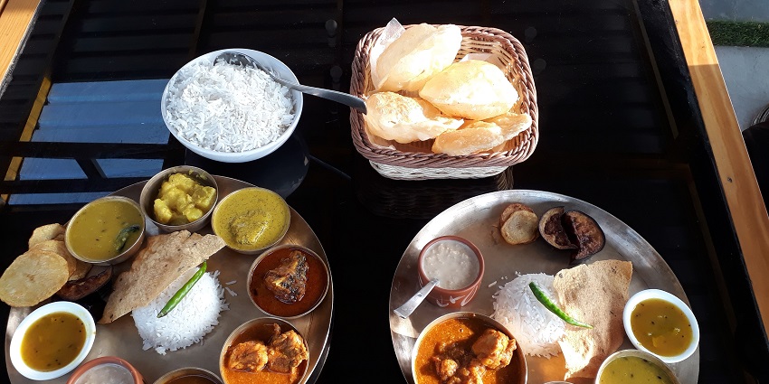 A picture of a restaurant table with special Bengali delicacies placed over it
