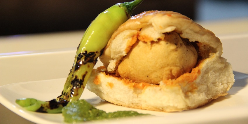 Close up image of a vada pav, a famous local snack served nearby